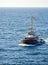 A tugboat with a Danish flag navigates on the sea