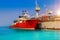 Tugboat moored alongside hear floating dock in the blue sea