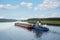 Tugboat moves barge on the Volga river