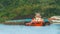 Tugboat pulling barge full of black coal in Mahakam river, Borneo, indonesia