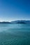 Tugboat pulling barge on a sunny day. Gastineau Channel, Juneau, Alaska, USA.