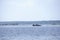 Tugboat pushes sand debris along the river