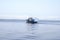 Tugboat pushes sand debris along the river