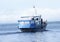 Tugboat pushes sand debris along the river