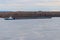 Tugboat pushing a heavy long barge on river Dnieper