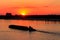 Tugboat pushing heavy long barge on the river Dnieper at sunset