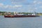 Tugboat Rechnoy-76 with a barge against the background of the central part of the city of Myshkin