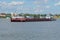 Tugboat `Rechnoy-76` with a barge working as a ferry on the city ferry across the Volga river