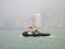 A Tugboat in Victoria Harbour Hong Kong in Front of Skyline