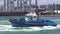 Tugboat works at Captain Cook Wharf in Ports of Auckland, New Zealand