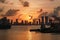 Tugboats going towards a romantic and colorful sunset over the caribbean sea