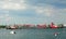 Tugboats help guide a freighter through Boston Harbor