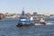 Tugs lining up barge for transit of hurricane barrier