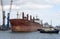 Tugs moving a bulk carrier, Port of Southampton, UK