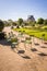 The Tuileries garden in Paris with the famous metal lawn chairs and the Louvre palace