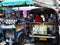 A tuk tuk goes through a narrow alley in Bangkok