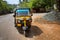 Tuk tuk taxi driving in the street in India