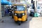 Tuk Tuk or Taxi tricycle in yellow color on the road, Lifestyle of traffic in Phnom Penh. It is a three-wheeled motorized vehicle