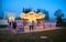 Tula city, Russia - May 2019: beautiful carousel with numerous glowing lamps, small bicycle, people and children are in Kremlin