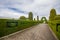 TULCAN, ECUADOR - JULY 3, 2016: cemetery path with geometrical designs on the trees