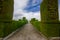 TULCAN, ECUADOR - JULY 3, 2016: cemetery path with plants sculptures on the sides