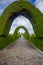 TULCAN, ECUADOR - JULY 3, 2016: cemetery path with some arcs and other plants sculptures