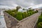 TULCAN, ECUADOR - JULY 3, 2016: man walking through a cemetery path next to the topiary garden