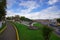 TULCAN, ECUADOR - JULY 3, 2016: some autos driving on the street next to an empty park