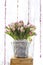 Tulip flower bouquet over blurred white sheer curtain background