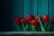 tulips are in the corner in front of a wooden background with enough copy space, ai generative