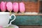 Tulips and cup and saucer with painted wooden background, mother's day