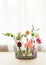 Tulips in glass jars on a tray in white room