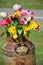 Tulips inserted into a rusty drum/bottle/jug.