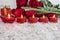 Tulips, roses flower and heart shaped candle on an snow like background