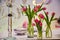 Tulips on the table in transparent vases