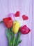 Tulips on a wooden red heart celebration