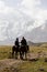 Tulpar, Kyrgyzstan August 21 2018: Two Kyrgyz riders ride their horses to base camp at the foot of Peak Lenin in Kyrgyzstan