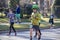 Tulsa USA 3 - 16 - 2019 Man in sequined green top hat surrounded by other people jogging down urban residential street in annual