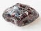 tumbled Almandine garnet crystals on white marble