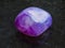 tumbled Amethyst crystal gem on dark