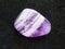 tumbled Amethyst gem stone on dark