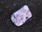 tumbled Amethyst gemstone on dark background