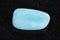 tumbled Aquamarine (blue beryl) gemstone on dark