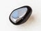 tumbled black obsidian gem stone on white