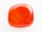 tumbled carnelian gem on white marble