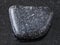 tumbled Chromite stone on dark background