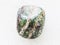 tumbled chrysotile gemstone on white marble