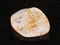 tumbled Citrine gem stone on dark background