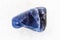 tumbled Dumortierite gemstone on white marble