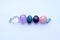 Tumbled gems of various colors. Amethyst, rose quartz, agate, apatite, aventurine, rock crystal on white background